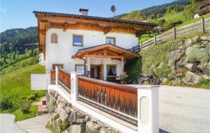 a house on a hill with a motorcycle on a balcony at Stunning Apartment In Aschau With Wifi in Aschau