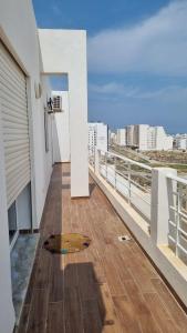a balcony of a building with a view of the city at Le 6éme in Sousse