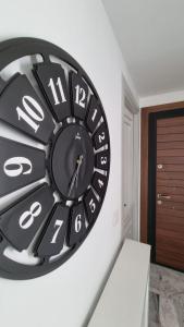 a black and white clock on a wall at Le 6éme in Sousse