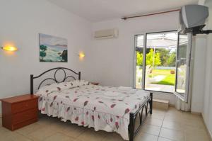 a bedroom with a bed and a large window at Villa Iris in Prinos