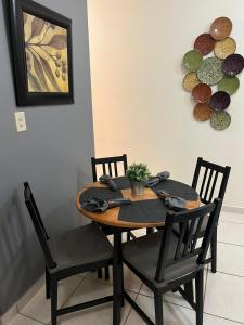 a dining room table and chairs with a plant on it at Casa Maria 2BR Apt with terrace in Levittown