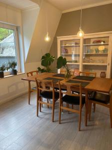 a dining room with a table and chairs at Charming apartment in Ålesund center with free parking in Ålesund