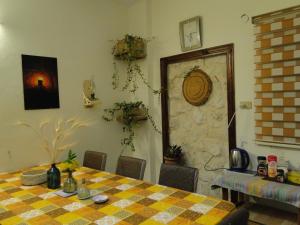 a dining room with a table and a stone wall at ( b&b ) Gadara rent room in Um Qeis