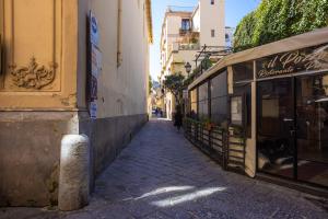 a person walking down a street next to a building at Pupatella Luxury Suite in Sorrento