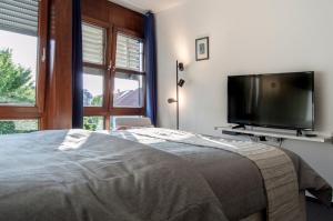 um quarto com uma cama e uma televisão de ecrã plano em Zentrale ruhige Wohnung mit Parkplatz em Paderborn