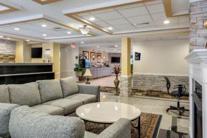 a living room with a couch and a table at Best Western Plus New England Inn & Suites in Berlin