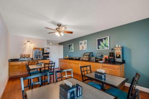 a kitchen and dining room with tables and chairs at SureStay Plus Hotel by Best Western Berkeley Springs in Berkeley Springs