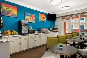 a restaurant with tables and chairs and a counter at SureStay Plus Hotel by Best Western The Villages in Lady Lake
