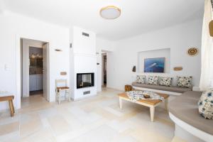 a living room with a couch and a fireplace at Villa Anneza Nikola in Angairiá