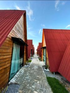 a row of buildings with red roofs and a pathway at Pousada Al Mare Beach in Luis Correia