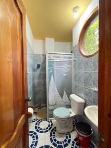a bathroom with a toilet and a sink at Hostal Brisas Del Mar in Puerto Villamil