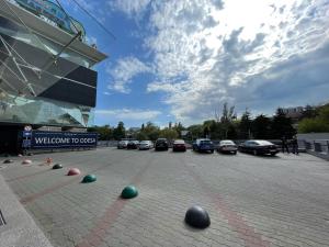 a parking lot with cars parked in front of a building at Gagarinn in Odesa