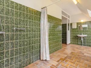 a green tiled bathroom with a shower and a sink at Rustic Retreat in Gettrup - By Traum Ferienwohnungen in Sindrup +29 photos