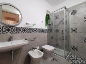a bathroom with a sink and a toilet and a mirror at SOLE MIO Vacation in San Vito lo Capo +26 photos