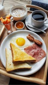 a plate of breakfast food with eggs ham and toast at Grand Bayan Hotel & Apt at Nile Plaza in Cairo