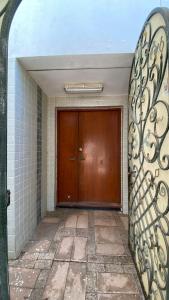 een grote houten deur in een kamer met een tegelvloer bij فيلا رضوى الخير in Madīnat Yanbu‘ aş Şinā‘īyah