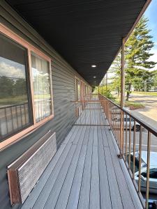 a porch of a building with a bench on it at Rosewood Garden in Wisconsin Dells