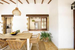 a dining room with a wooden table and chairs at Villa en Costa Brava in Calonge