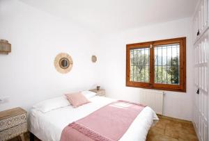 a white bedroom with a bed and a window at Villa Boheme Costa Brava in Calonge +34 photos