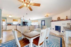 a kitchen and dining room with a table and chairs at Smooth Sailing 14105 in Ocean City