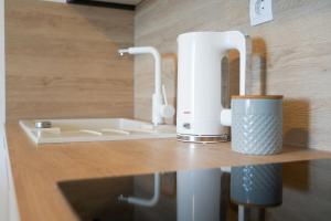 a kitchen counter with a white appliance on a shelf at Apartmani Eterović in Baška Voda +57 photos