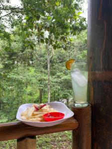 a plate of food on a table with a drink at Joben Ecolodge in Tetebatu