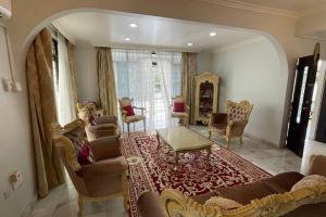 a living room with a couch and chairs and a table at Spacious Home in Kuala Terengganu in Kuala Terengganu