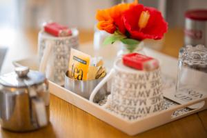 a tray with a vase with a flower in it at Boutique Country House Aldergrove in Crumlin +20 photos
