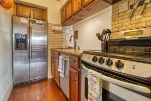 a kitchen with stainless steel appliances and wooden cabinets at Breathtaking Sunsets, Views, Pool, Heaven Awaits! in Gatlinburg