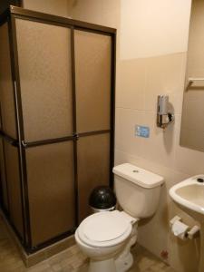 a bathroom with a toilet and a sink at El Prado Capsule Hostel in La Paz