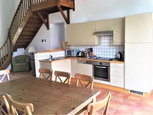 a kitchen with a table and chairs in a room at Villa with covered terrace in rural Chalais in Chalais