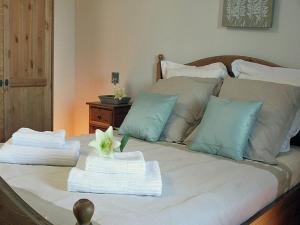 a bed with two towels and a flower on it at Villa with covered terrace in rural Chalais in Chalais +16 photos