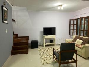 a living room with a couch and a tv at Casa Mía in Resistencia