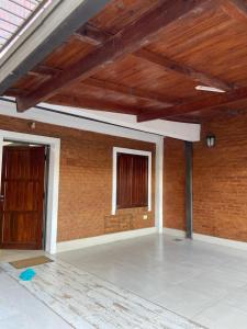an empty room with a brick wall and a window at Casa Mía in Resistencia