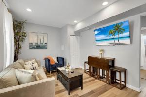 a living room with a couch and a piano at Wellington Garden in West Palm Beach