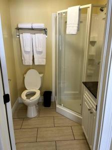 a bathroom with a toilet and a shower and towels at Home Away From Home in Stanley Bridge