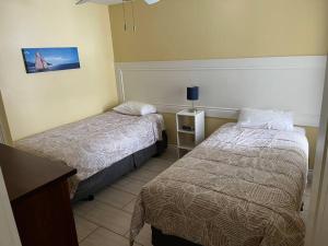 a hotel room with two beds and a table at Home Away From Home in Stanley Bridge