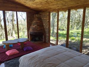 a bedroom with a bed and a fireplace at CABAÑAS ALASKA in Sesquilé