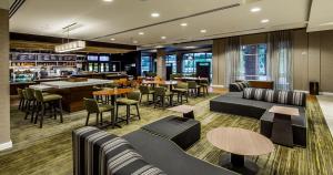 a restaurant with couches and tables and a bar at Courtyard by Marriott Columbia Cayce in Cayce