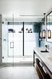 a bathroom with a glass shower and a sink at Dream Hollywood, by Hyatt in Los Angeles