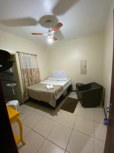 a bedroom with a bed and a ceiling fan at HOTEL SÃO LUÍS in Uruguaiana