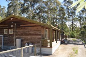 a small wooden cabin with a fence around it at Kookaburra Cabin in Warburton