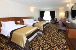 Postel nebo postele na pokoji v ubytování Arya Hotel Sakarya