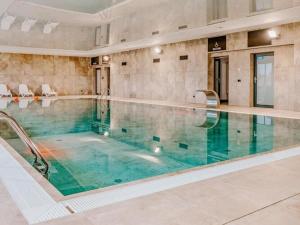 a large swimming pool in a large building at Beautiful apartment overlooking the river, swimming pool, sauna, Dziwnów in Dziwnów