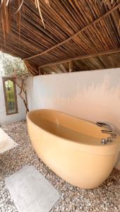 a bath tub in a bathroom with a wall at Villa el Oasis, luxurious Santa Marta getaway in Santa Marta