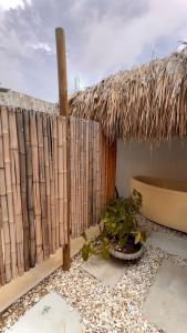 a patio with a fence and a potted plant at Villa el Oasis, luxurious Santa Marta getaway in Santa Marta