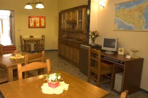 a kitchen with a table and a desk with a computer at I Colori Del Sole in Fiumefreddo di Sicilia