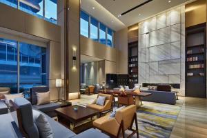a lobby of a hotel with couches and tables at HongQiao Primus Residence Apartment - National Exhibition Center in Shanghai