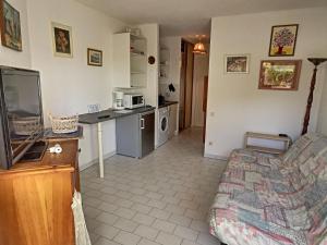 een woonkamer met een tv en een keuken bij Appartement Saint-Cyprien, 1 pièce, 2 personnes - FR-1-732-6 in Saint-Cyprien