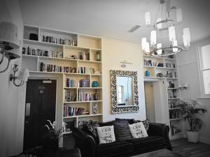 a living room with a couch and book shelves at The swan at compton in Compton